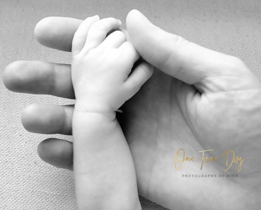 photo of baby's had in dad's by one fine day photography by reen