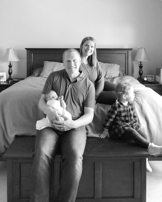 black and white family photo laughing on the bed by one fine day photography by reen